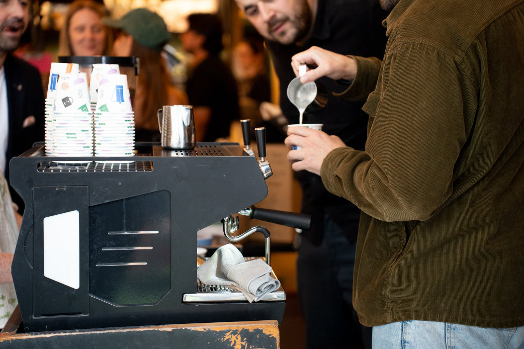 Person pouring steamed milk