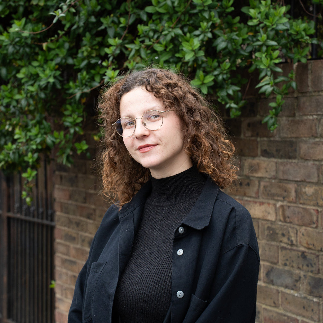 Employee photo in front of brick wall